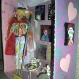 Shadow box of Barbie with paintbrush and paintings