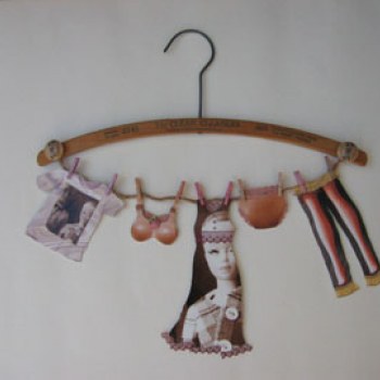 Vintage clothes hanger with paper Barbie clothes