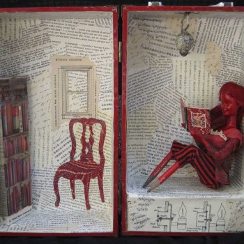 Barbie reads in her study.