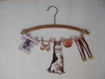 Vintage clothes hanger with paper Barbie clothes