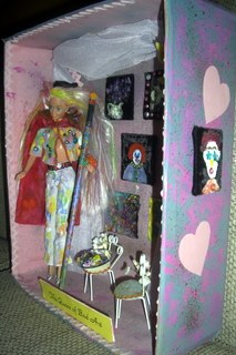 Shadow box of Barbie with paintbrush and paintings